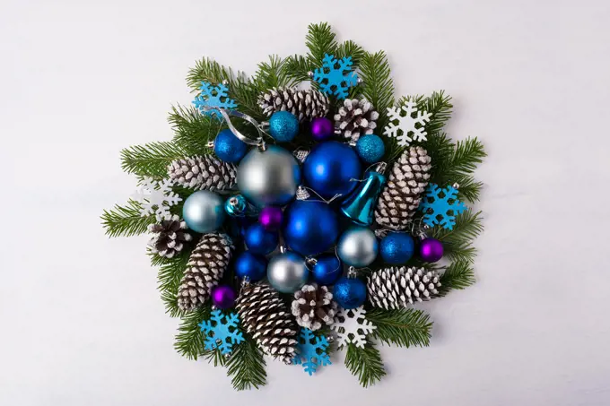 Christmas wreath with blue color shades ornaments. Christmas decoration with blue balls, fir branches and pine cones. Christmas greeting background. 