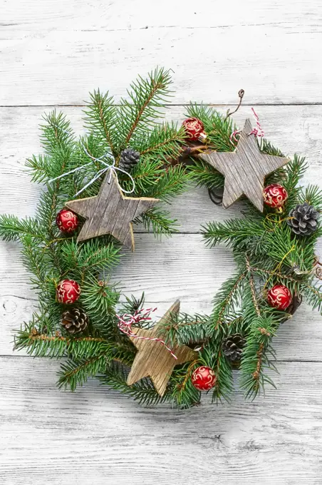 Xmas background with wreath Christmas. Noel wreath of fir branches decorated with Christmas star toys