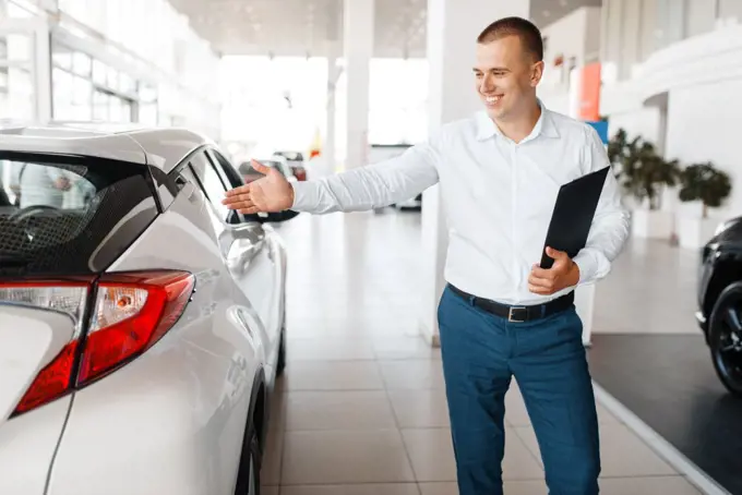 Salesman shows new car in showroom. Male customer buying vehicle in dealership, automobile sale, auto purchase