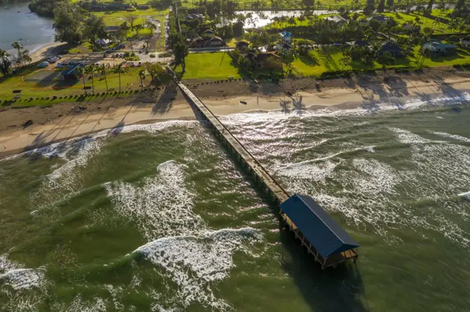 Aerial panoramic image at sunrise off the coast over Hanalei Bay and pier on Hawaiian island of Kauai. Aerial drone shot of Hanalei bay and beach on the north shore of Kauai in Hawaii