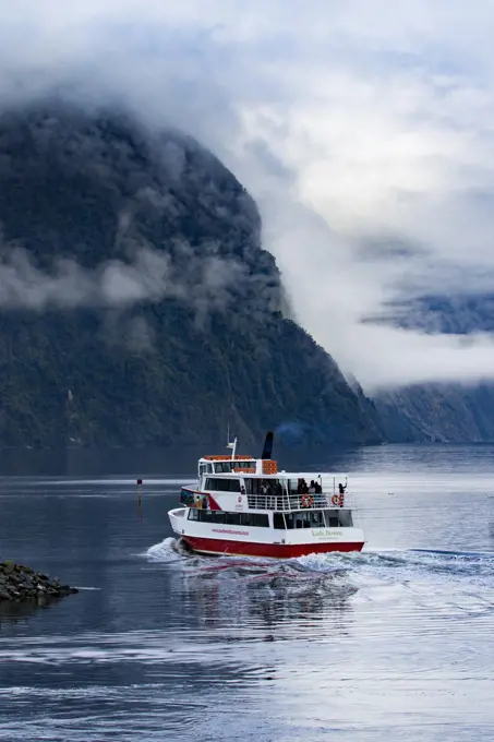 MILFORD SOUND NEW ZEALAND - AUGUST 30,2015 : tourist boat cruising in harbor of milford sound most popular natural traveling destination in southland new zealand