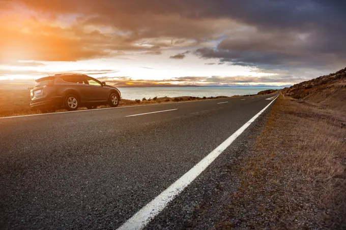 traveling car and beautiful scenic of lake pukaki in aoraki - mt.cook national park new zealand