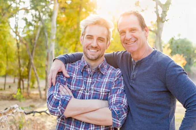 Happy Caucasian Father and Son Portrait Outdoors.