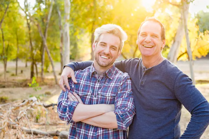 Happy Caucasian Father and Son Portrait Outdoors.