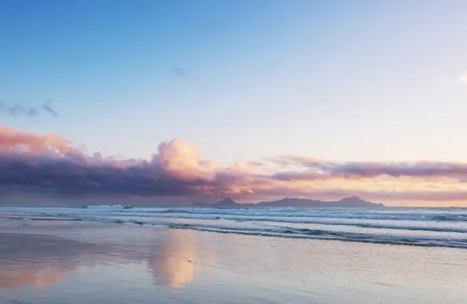 Beautiful Sunset at the Ocean Beach, New Zealand. Inspiring natural and travel background