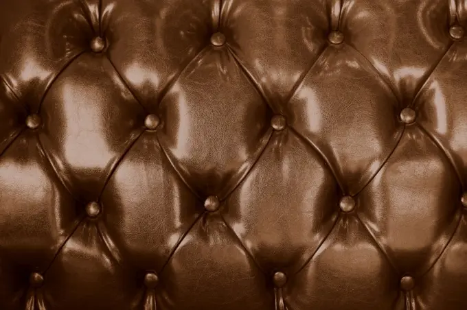 Sofa leather brown color vintage old texture furniture tile background.