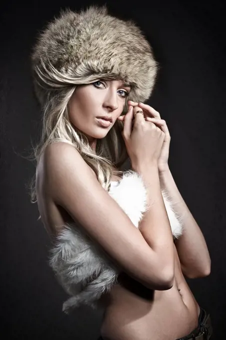 Stunning blonde beauty over dark studio background