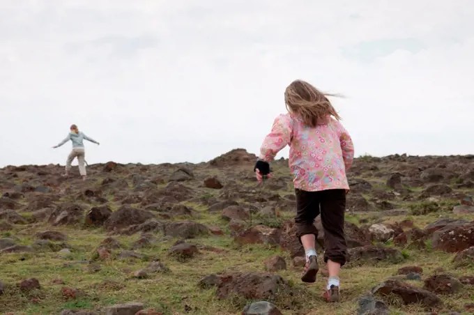 Girl running in field in Kenya