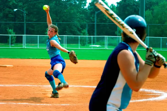 Female Softball Player Pitching To A Batter