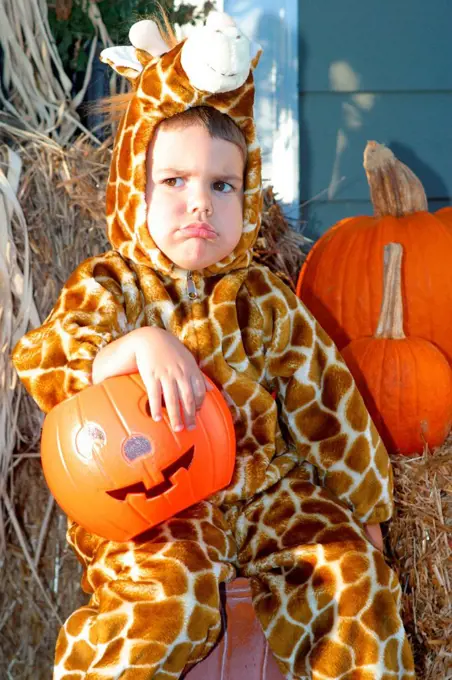 Caucasian Boy Wearing A Giraffe Costume And Frowning On Halloween