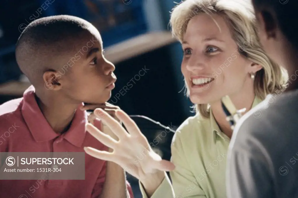 Female teacher talking to students in a class