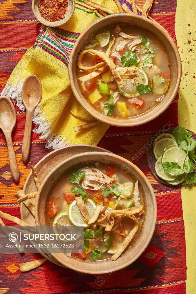 Mexican soup with tortillas and lime