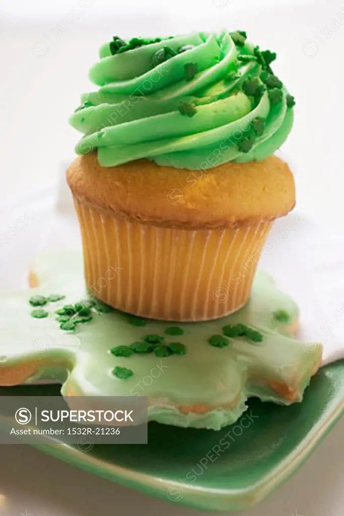 Muffin with green cream & shamrock biscuit for St. Patricks Day