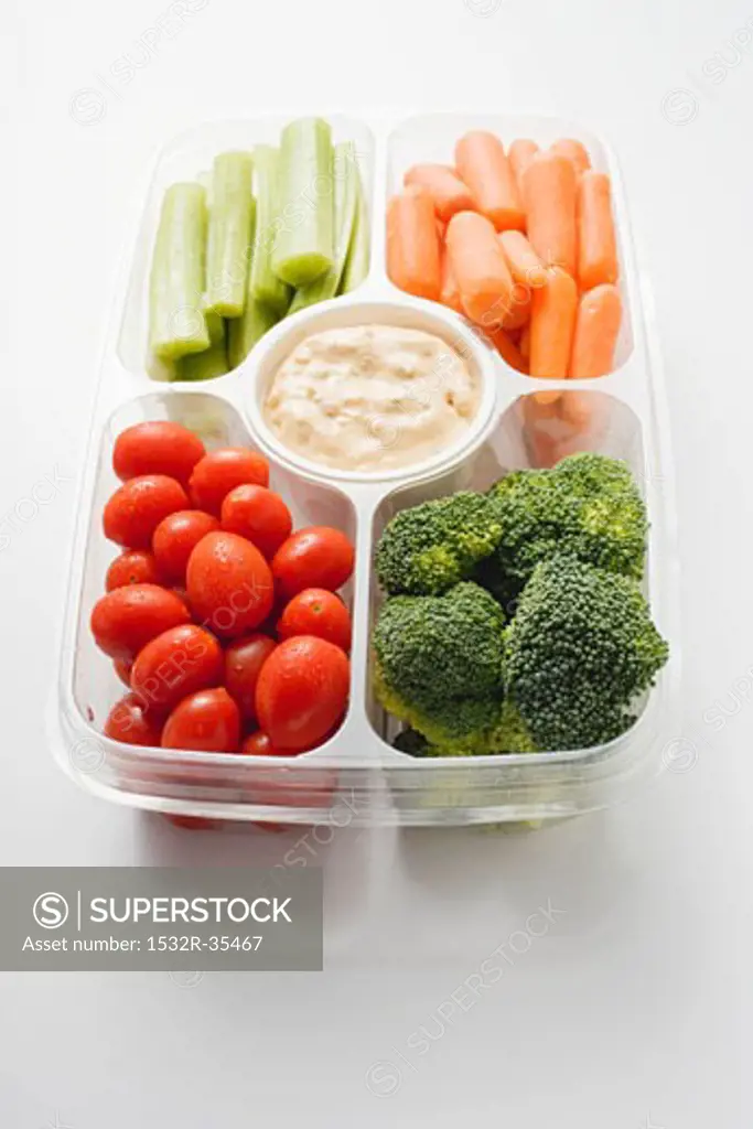 Assorted vegetables with dip in plastic tray