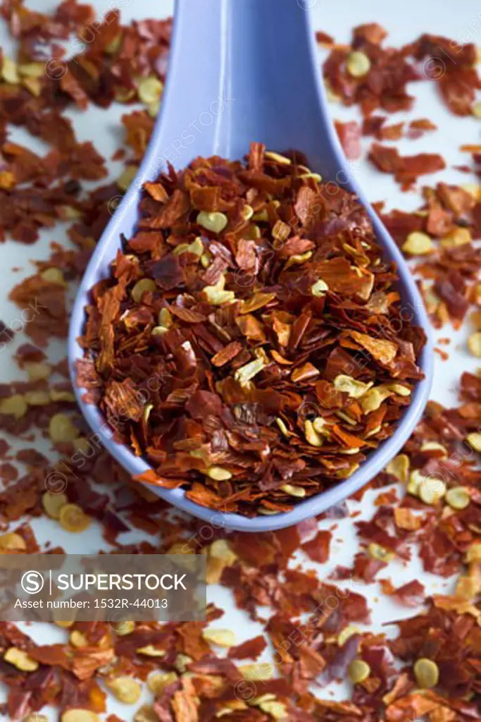 Dried chilli flakes with blue spoon