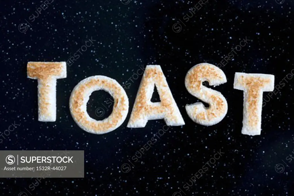 Toast letters spelling the word TOAST on black background