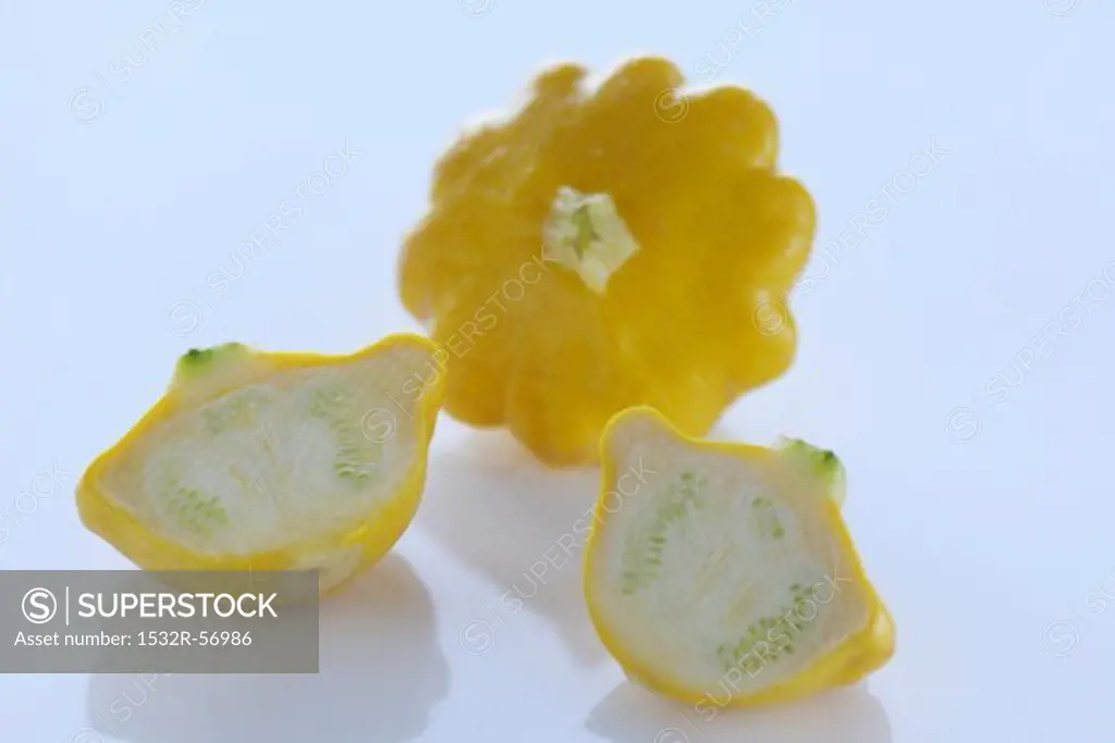 Yellow patty pan squash, whole and halved