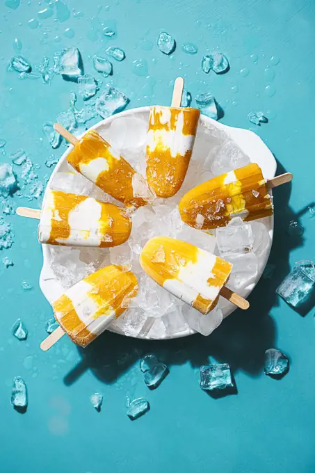 Homemade mango and coconut cream ice lolly