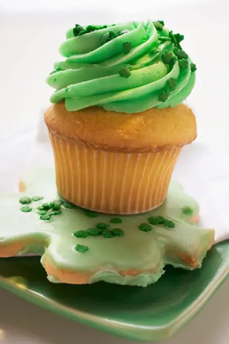 Muffin with green cream & shamrock biscuit for St. Patricks Day