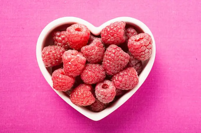 Raspberries in heart-shaped bowl