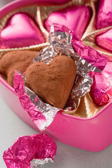 Pink chocolates in heart-shaped box