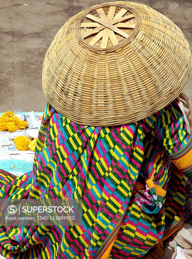 Women in colorful dress with cane basket hat , Ujjain, Madhya Pradesh , India