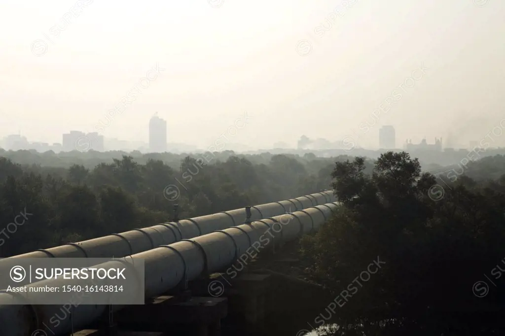 Big pipes carrying water to South Mumbai passes through Dharavi draped in smog ; Bombay Mumbai ; Maharashtra ; India