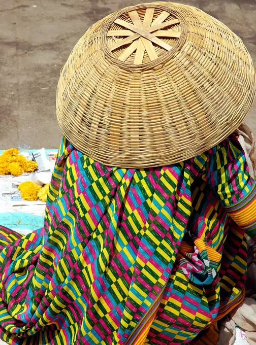 Women in colorful dress with cane basket hat , Ujjain, Madhya Pradesh , India