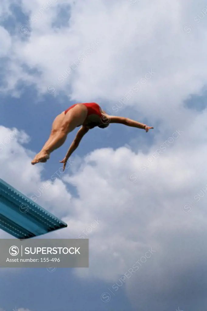 Low angle view of a woman diving from a diving board