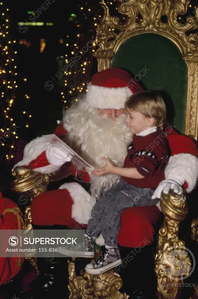 Santa Claus with a girl sitting in his lap