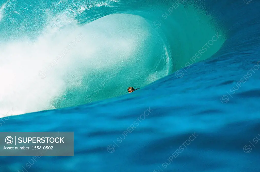 Young adult man surfing, Teahupoo, Tahiti, French Polynesia