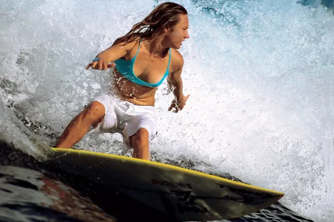 Young adult woman surfing, Tahiti