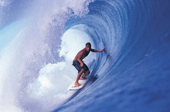 Young adult man surfing, Tahiti, French Polynesia