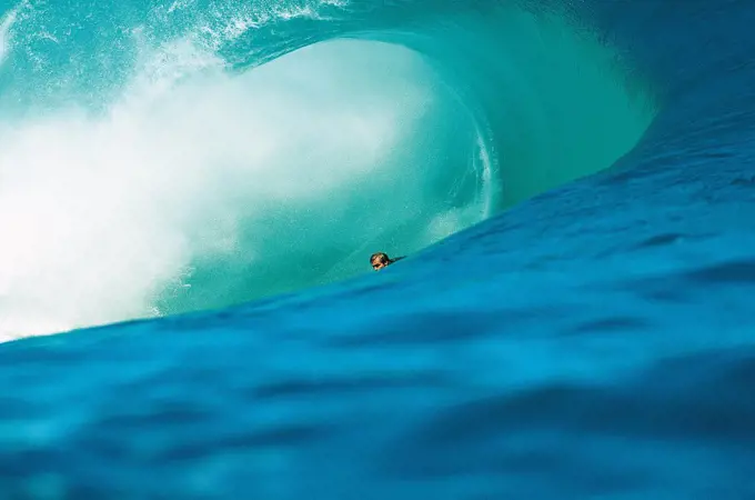 Young adult man surfing, Teahupoo, Tahiti, French Polynesia