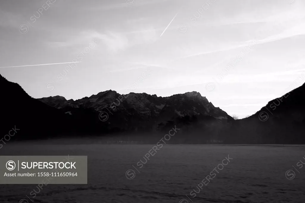 View on the Zugspitze in foggy atmosphere and in black-and-white,