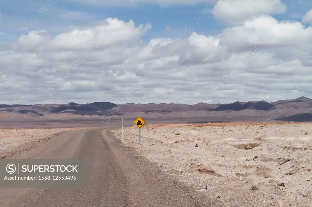 Street with warning of steep gradients in the desert, Atacama, Chile