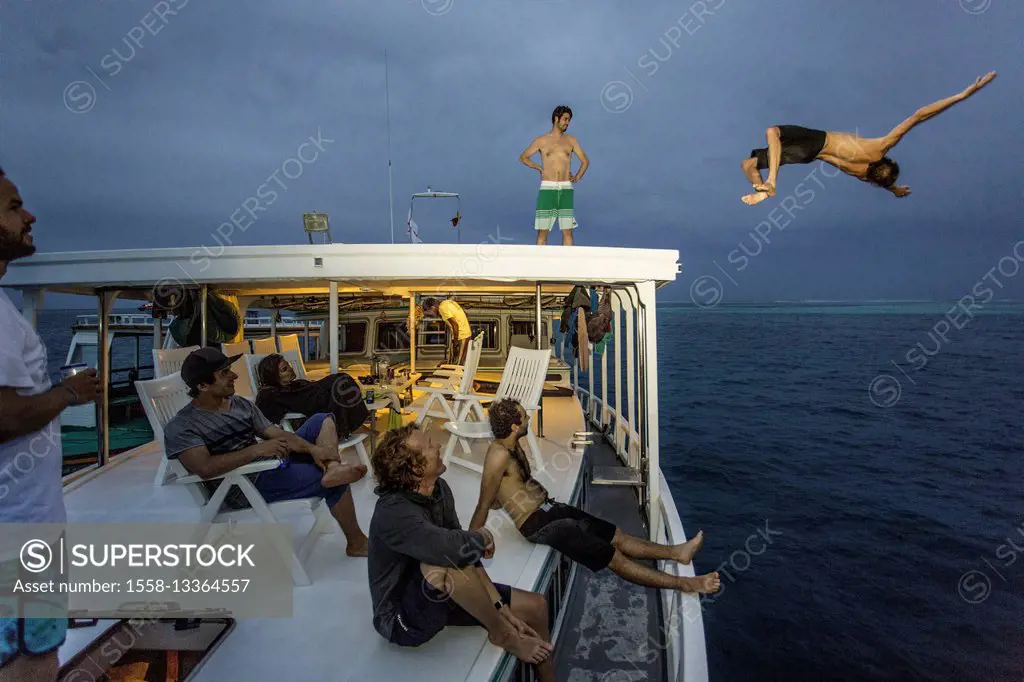 Boy is jumping from boat