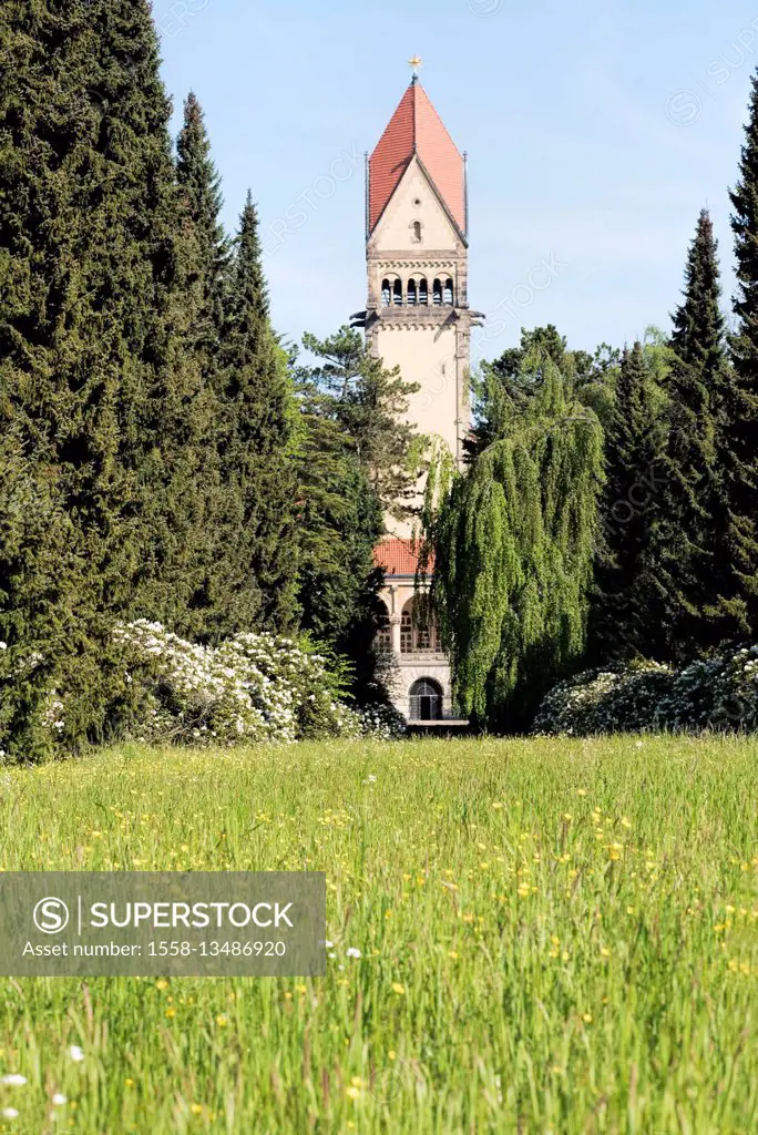 South cemetery of Leipzig, tower of the crematory picturesquely between meadow and trees,