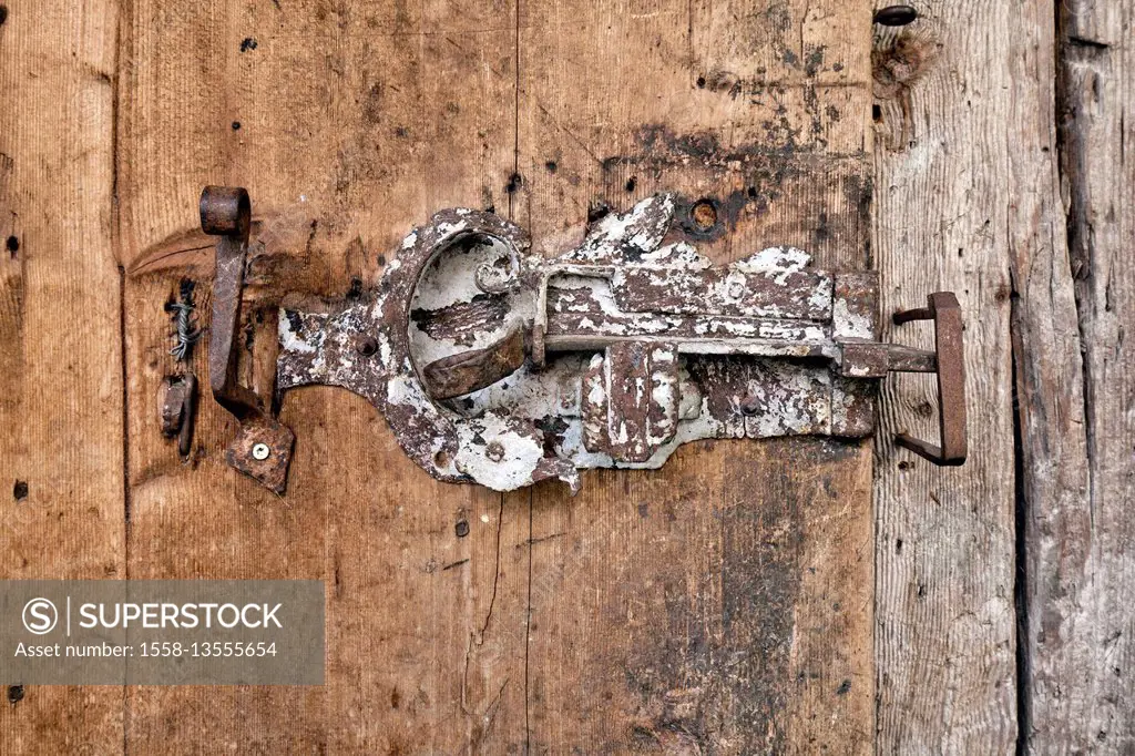 ancient door latch in wooden door