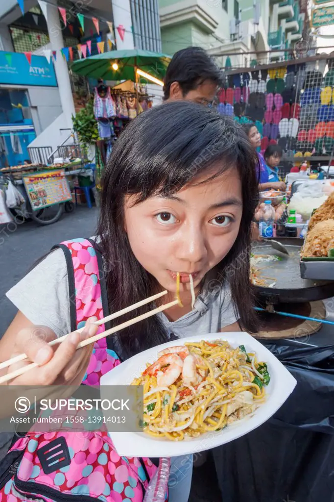 Thailand, Bangkok, Khaosan Road, Female Asian Tourist Eating Pad Thai