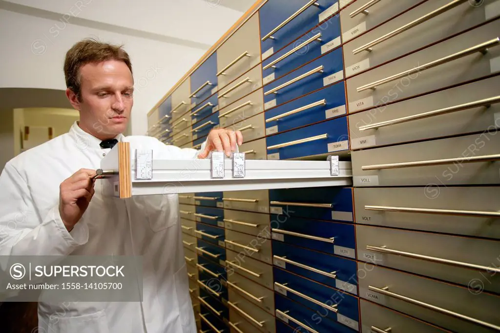 Chemist searches drug in chemist cupboard