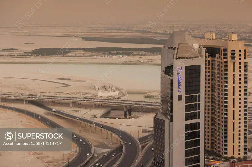 UAE, Dubai, Downtown Dubai, elevated desert and highway view towards Ras Al Khor with Radisson Hotel, dusk