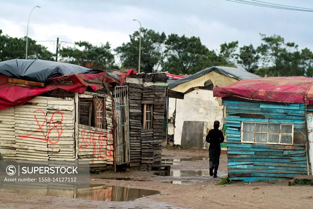 Houses and slums in the township of Langa in Cape Town reflecting in the puddles left behind by a heavy storm - South Africa