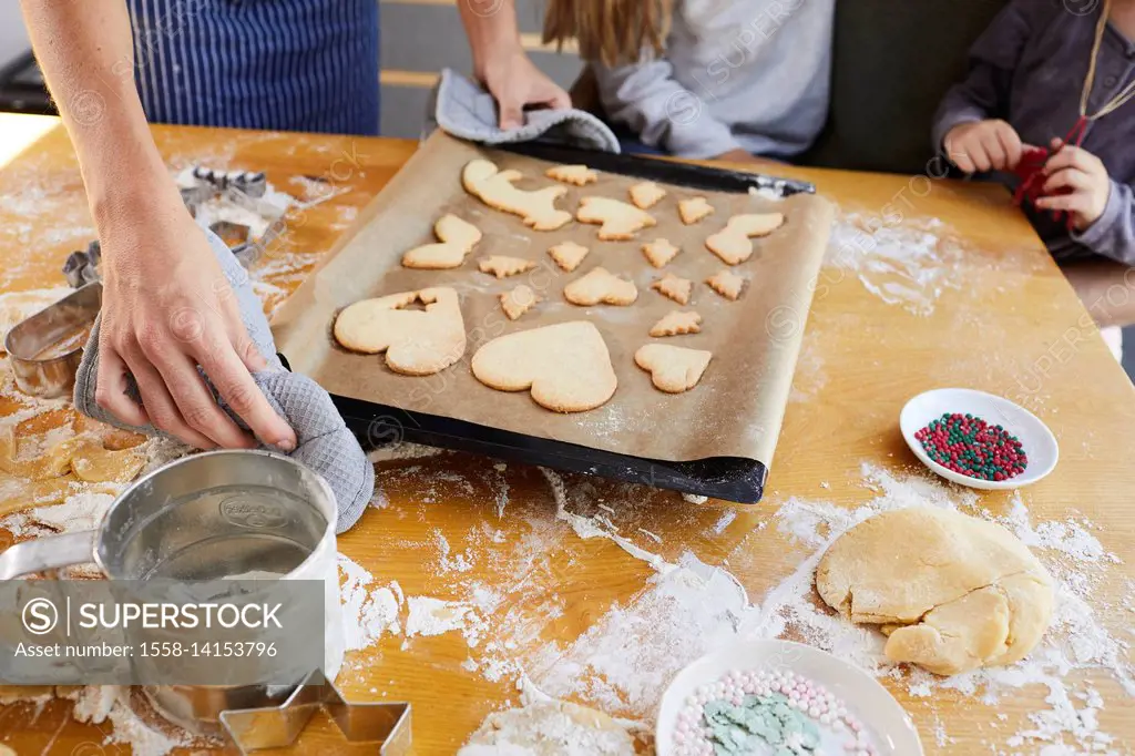 Family baking christmas cookies, baking tray, detail,