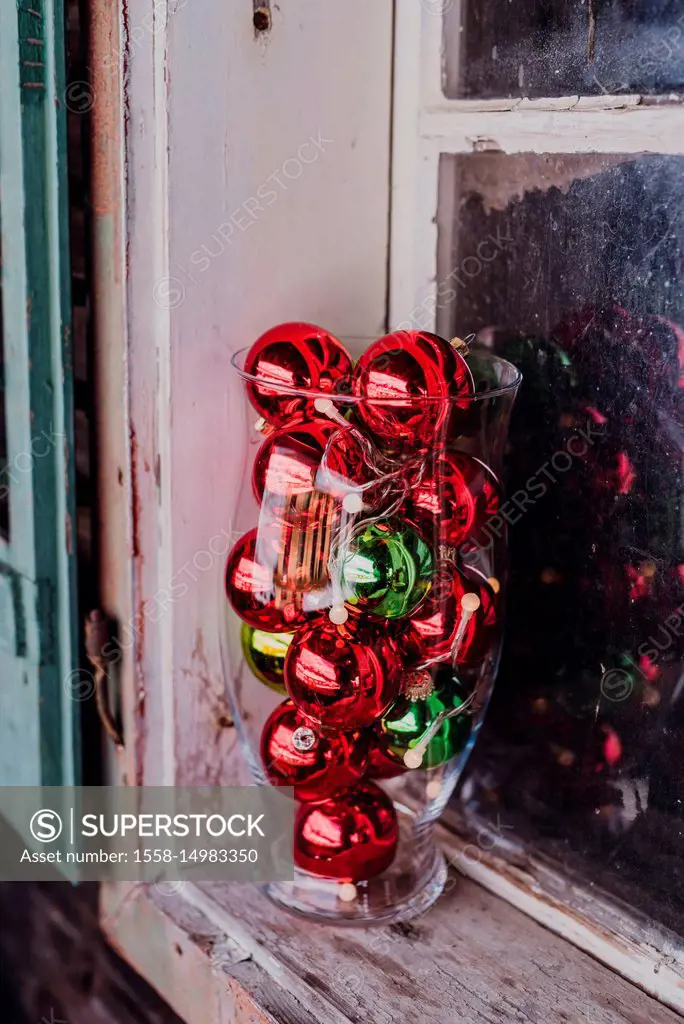 Windowsill, decoration, glass vase filled with christmas balls,