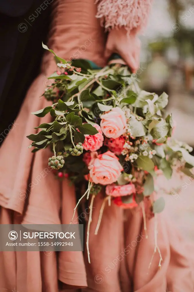 Bridal couple with flower bouquet, detail,