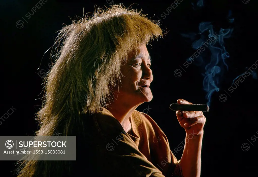 Woman with wig smoking a cigar Batanes Islands Philippines