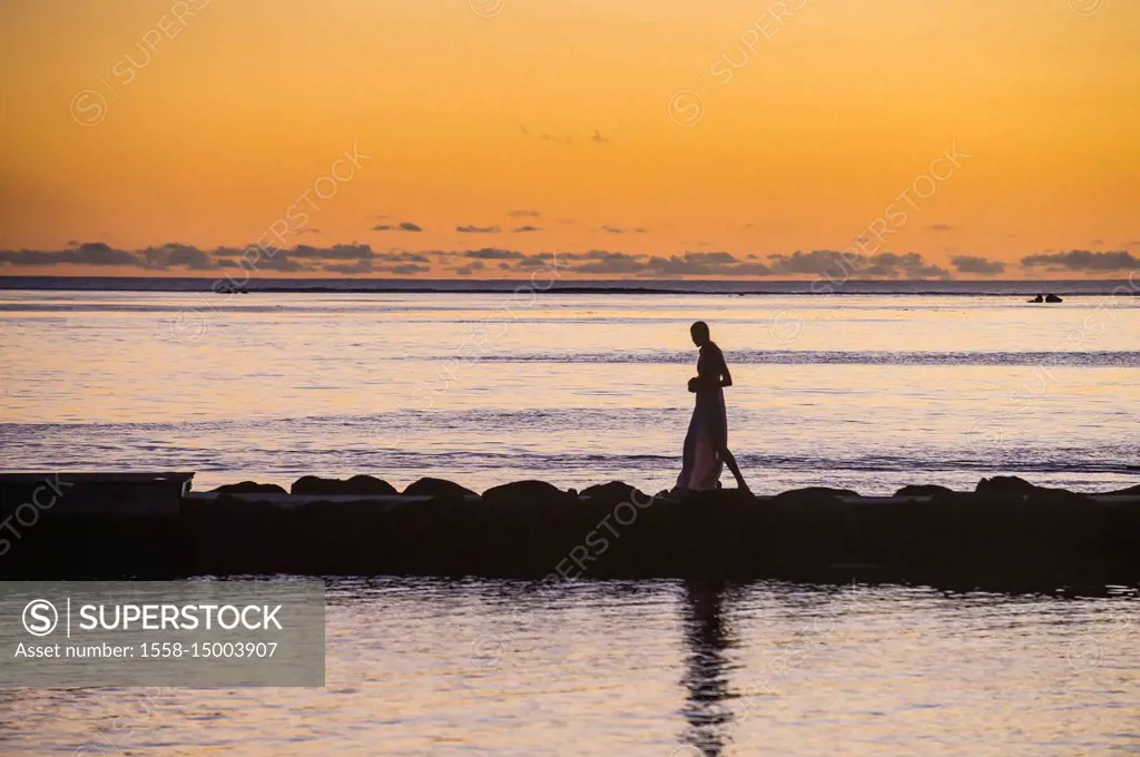 Woman walking on a pier at sunset, Papeete, Tahiti, French Polynesia