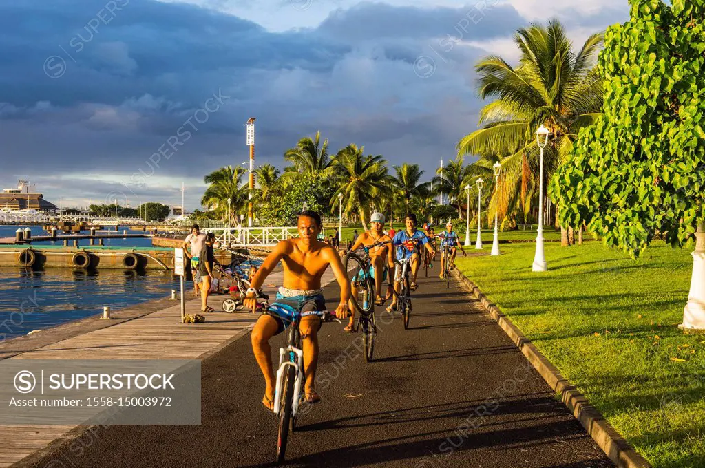 Local boys on their bicycles, Waterfront of Papeete, Tahiti, French Polynesia