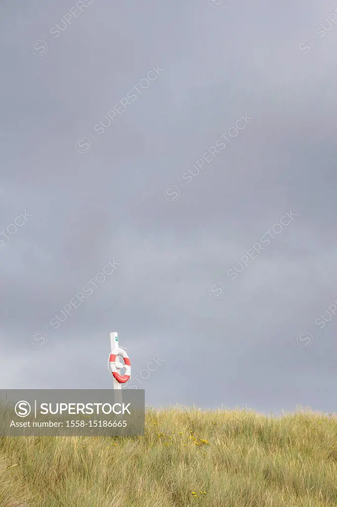 Lifebuoy in front of storm clouds on the beach of Vester Sømarken, Europe, Denmark, Bornholm,